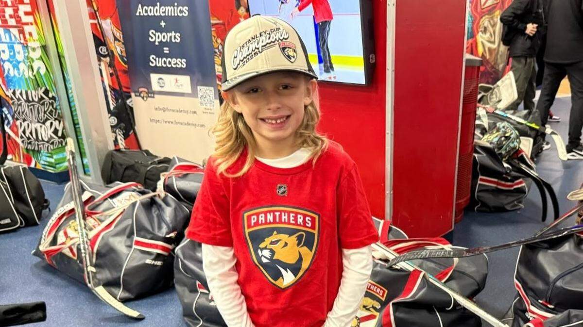 LJ Howells poses for a photo in a Florida Panthers shirt.