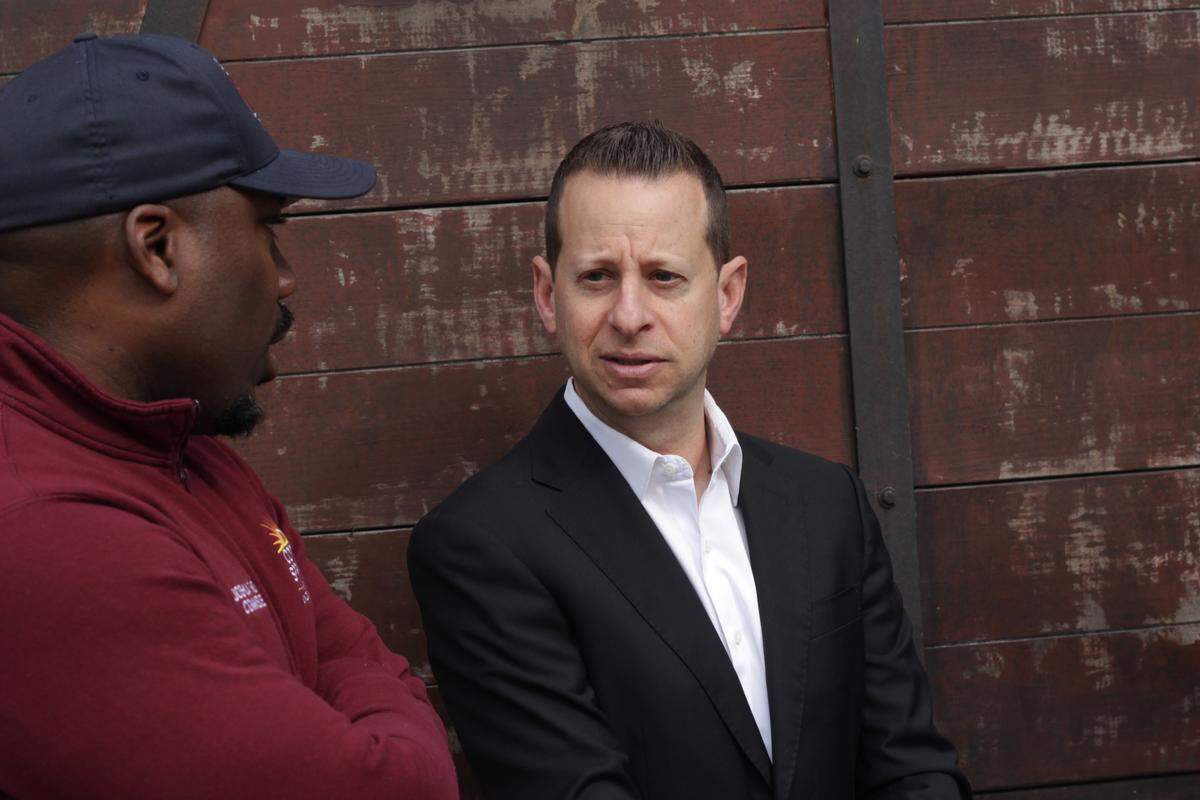 Jared Moskowitz, a U.S. representative for Florida’s 23rd congressional district, speaks with Commissioner Joshua Simmons after the official opening of the cattle car exhibit.