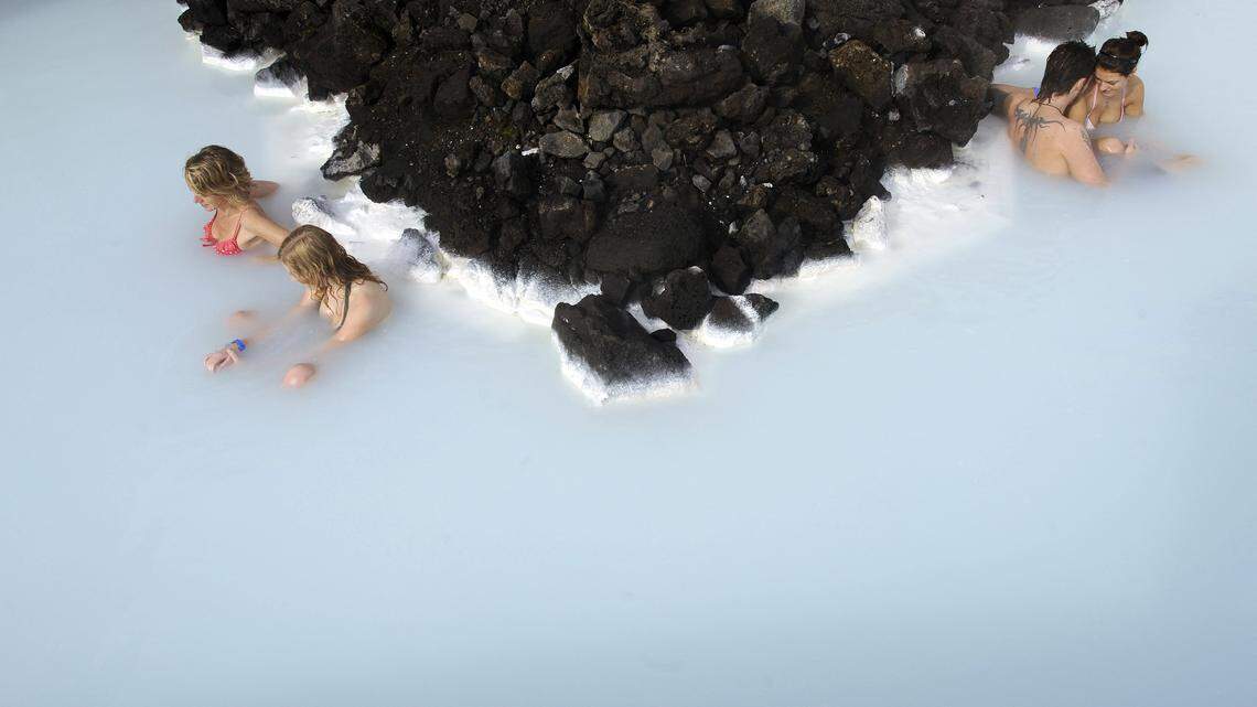 Tourists sit in the Blue Lagoon outside Reykjavik in Iceland