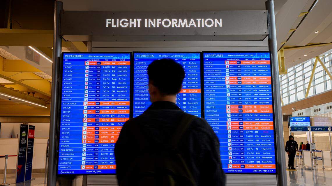 A departure board displays multiple canceled and delayed flights at Ronald Reagan Washington National Airport in Arlington, Virginia.