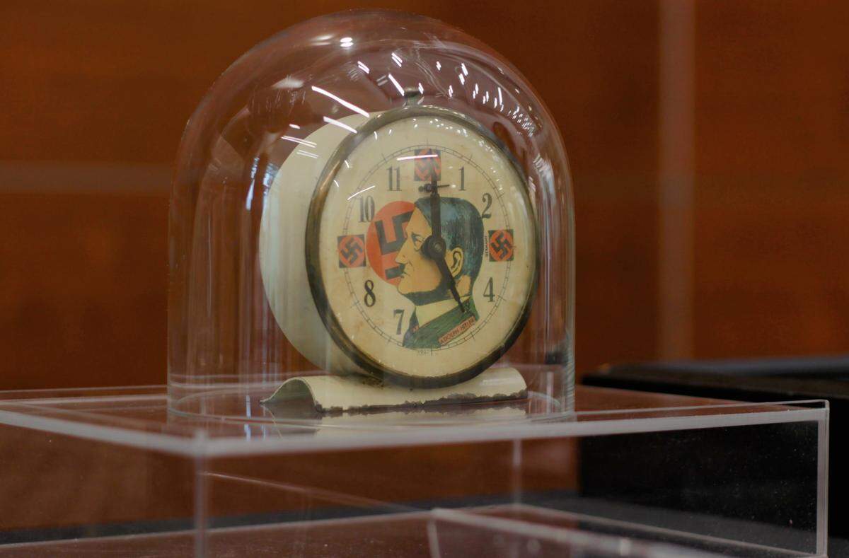 An alarm clock with Adolf Hitler’s face on it is one of the items in the Holocaust artifacts collection on display.