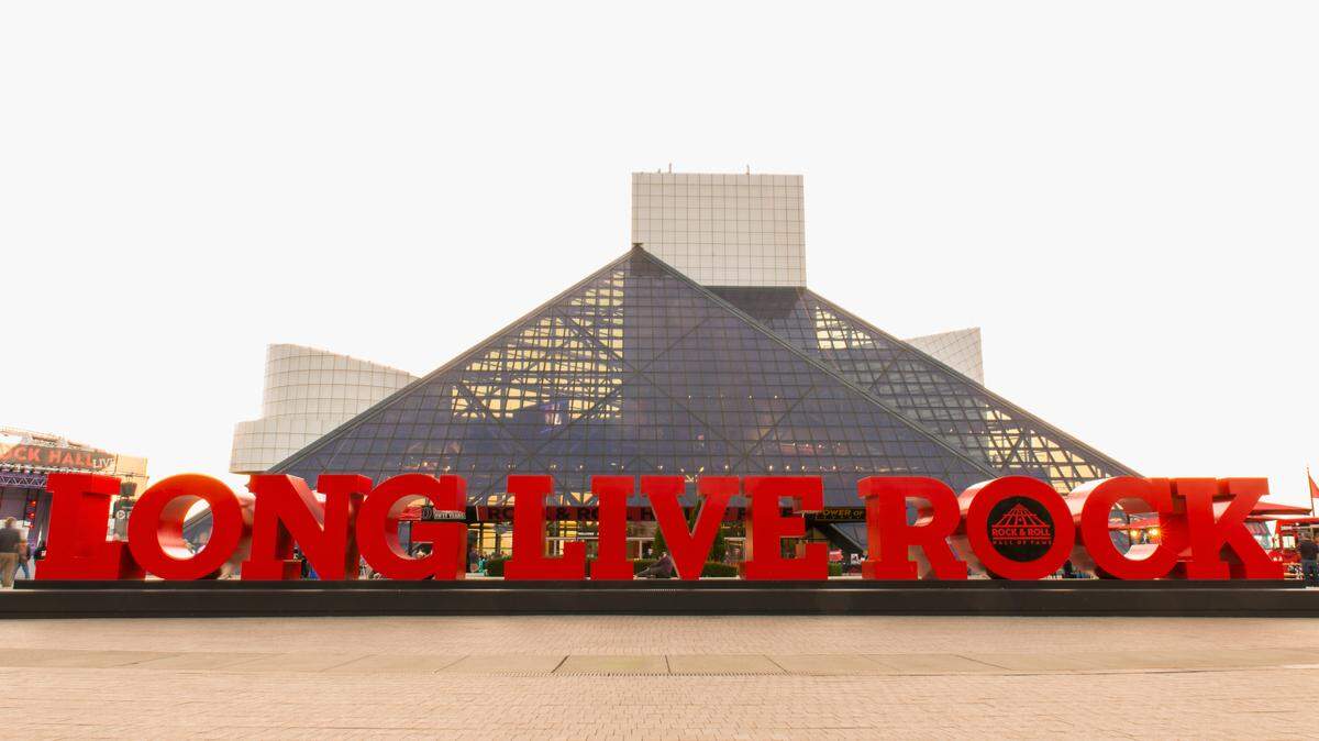 The outside of the Rock and Roll Hall of Fame and Museum in Cleveland, Ohio with a sign reading “LONG LIVE ROCK”