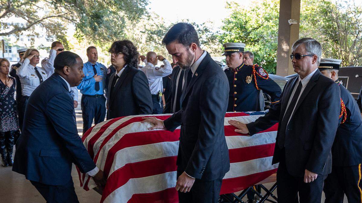 Pallbearers brought Russell Donovan’s flag-draped coffin to his final resting place in Our Lady Queen of Heaven Cemetery on Oct. 31.