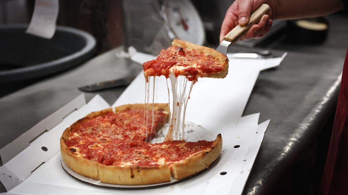A worker prepares a Chicago-style deep dish pizza at a Lou Malnati’s restaurant in Chicago, Illinois.