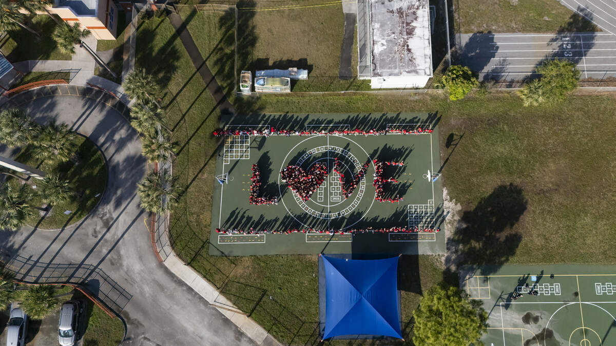Driftwood Elementary School students gather in the shape of the word “LOVE” as they participate in a day of commemoration honoring the victims of the Marjory Stoneman Douglas High School tragedy on Friday, Feb. 13, in Hollywood.