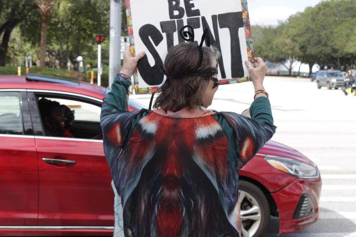 While stopped at a red light, some drivers and passengers like the ones pictured here cheered in support of the protesters.