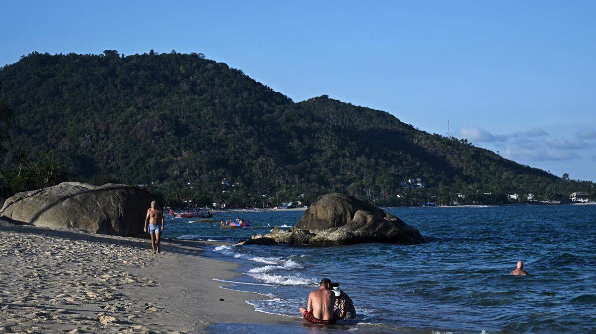 People relax on Lamai beach on Koh Samui island in the southern Thai province of Surat Thani.