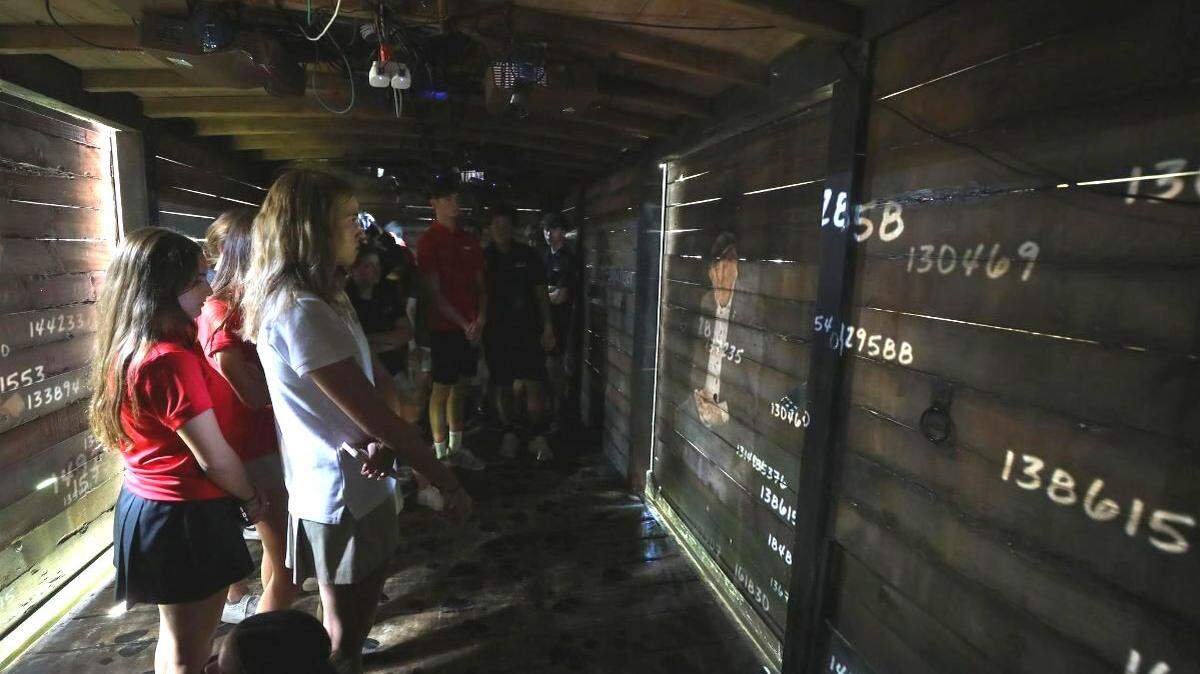 The traveling exhibit features a replica cattle car from World War II.