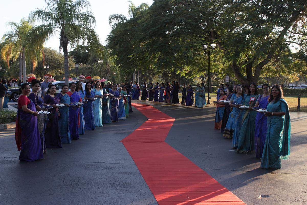 Women in traditional dress hold thalapoli, silver plates with flowers, signifying prosperity and respect. The practice is rooted in Hinduism in the Kerala state, but the blue and white hues chosen for the Nov. 18 ceremony represent the Virgin Mary.