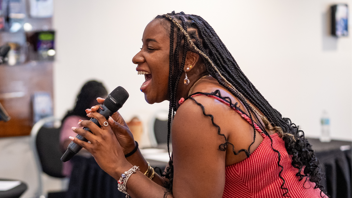 Woman singing during 2025 Juneteenth celebration in Coral Springs Center for the Arts