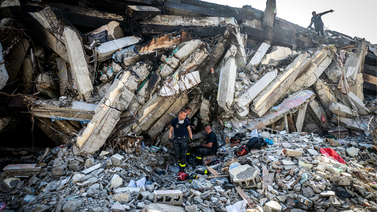 Rescue workers search a damaged building in Catia La Mar in Venezuela on Monday, June 29, after double earthquakes struck the nation’s northern coast on June 24.