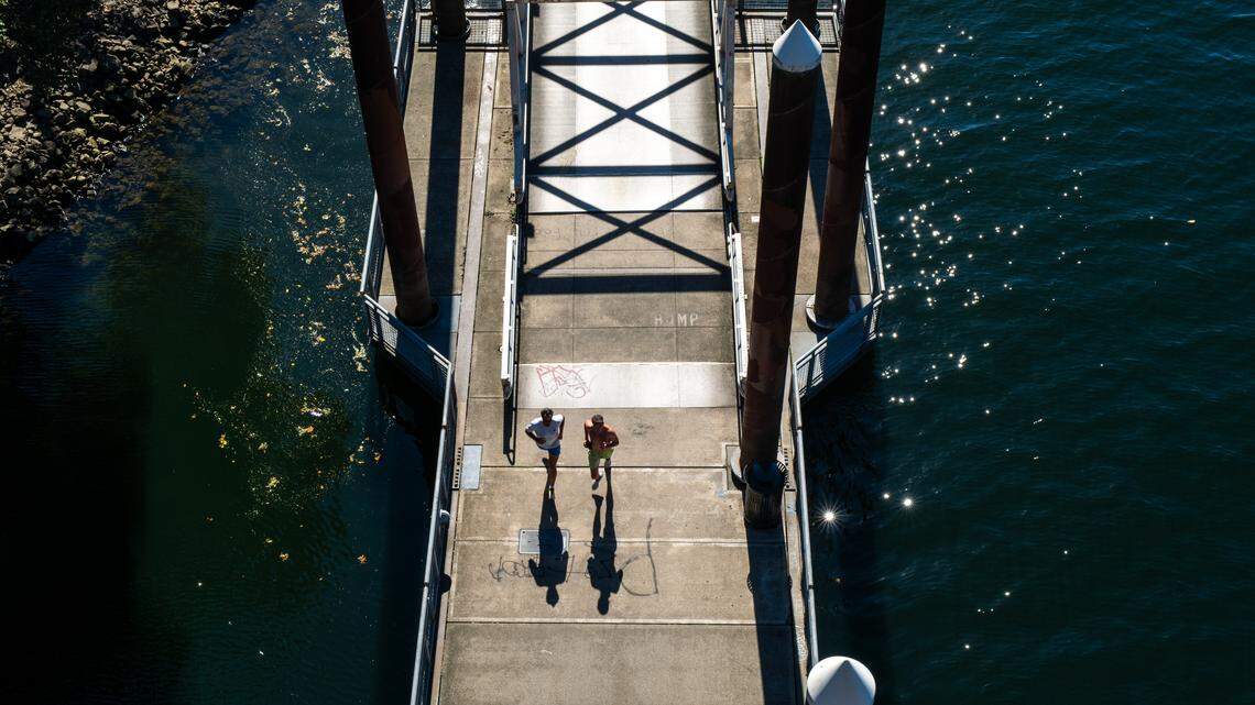 People run near the water through the downtown section in Portland, Oregon.