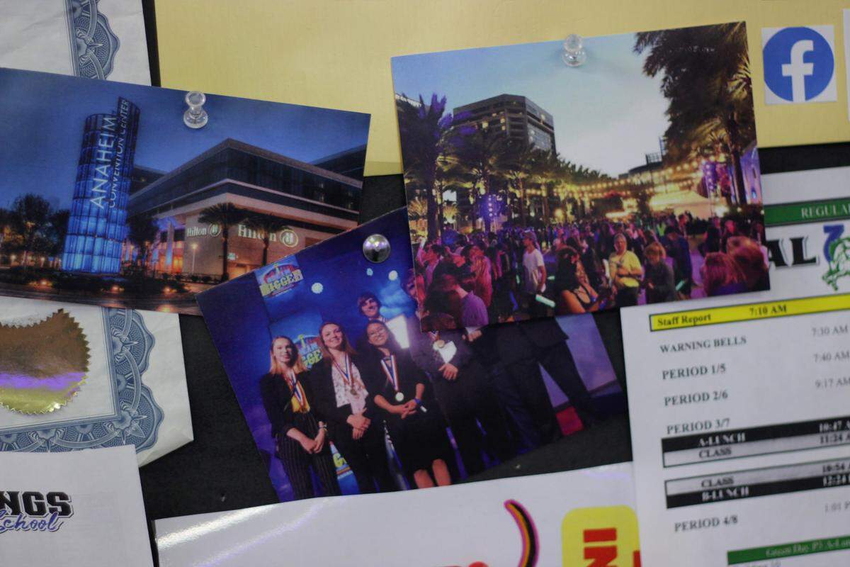 Displays on Jason Freedman’s walls include photos from past trips with student groups — many of them featuring first-place medals and trophies.