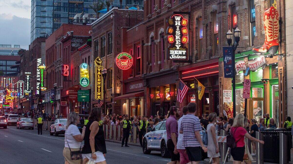 Tourists walk on Broadway Street in Nashville, Tennessee.