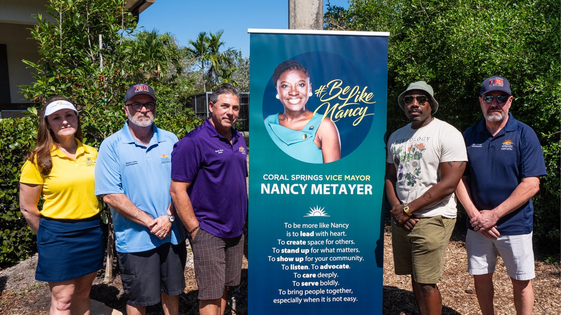 Members of the Coral Springs City Commission stand for a photo after formally dedicating a freshly planted tree in Vice Mayor Nancy Metayer Bowen’s name during the city’s annual Earthfest celebration.