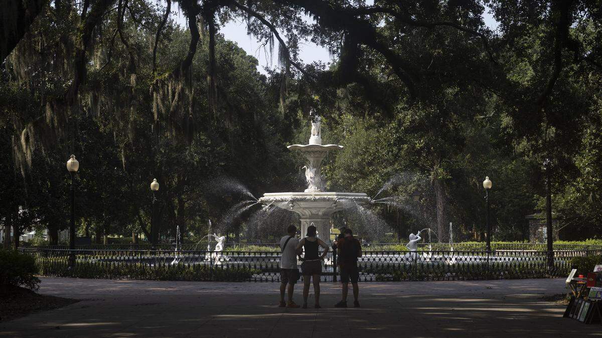People walk through Forsyth Park in Savannah, Georgia.