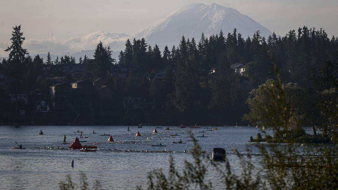 Mount Rainier is seen as athletes compete during the swim leg of the IRONMAN 70.3 Washington in Maple Valley, Washington.