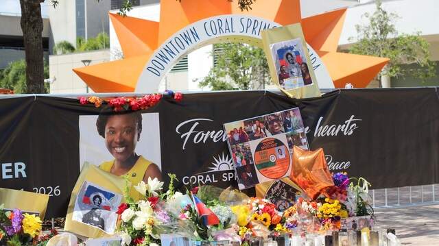 A memorial for Coral Springs vice mayor Nancy Metayer Bowen stands in front of City Hall’s iconic sun sculpture on April 6, 2026, days after mourners packed the adjacent lawn for a vigil in her honor.