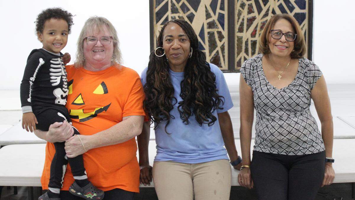 Staff and volunteers at Royal Palm Christian Church’s food pantry pose for a photo after one of its busiest non-holiday nights on record. Pictured from left to right: Tara Herman, Moya McFarlane and June Bookal.