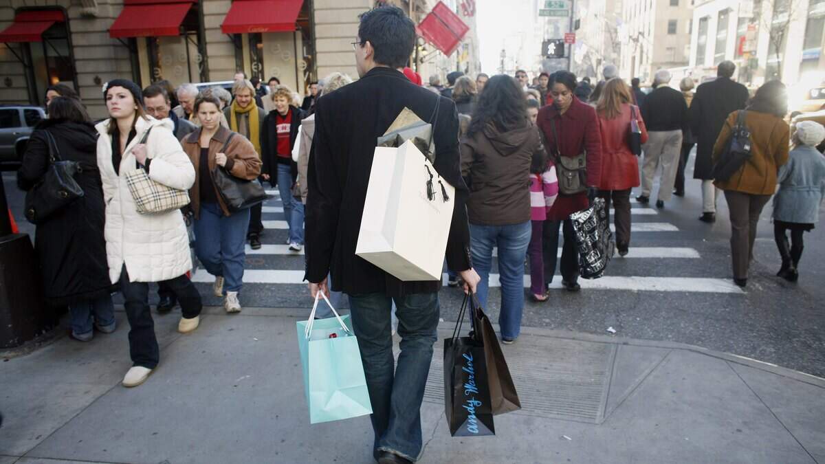 Shoppers walk along Fifth Avenue in New York City.
