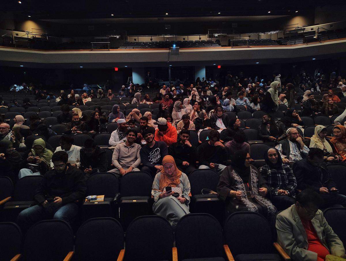 Attendees take their seats in the main theater at the Coral Springs Center for the Arts.