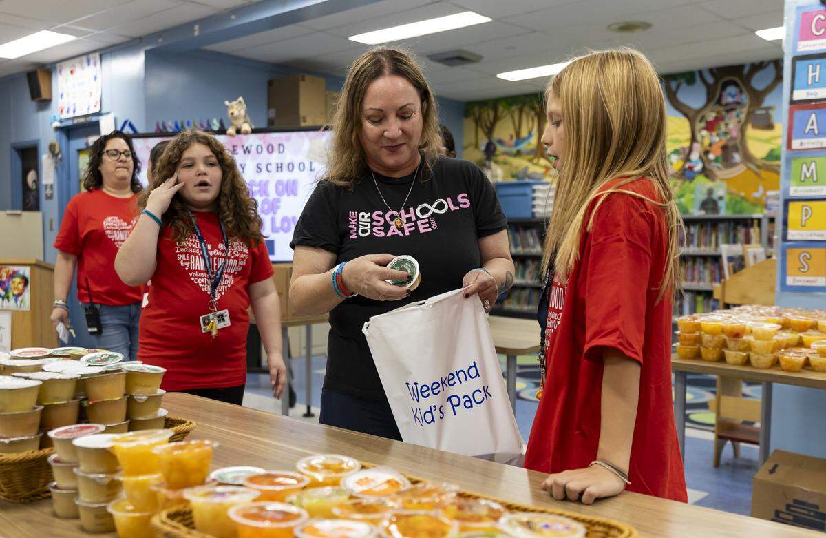 School Board Member Lori Alhadeff helps students prepare “Weekend Packs” for children in need as Ramblewood Elementary School participates in a day of commemoration honoring the victims of the Marjory Stoneman Douglas High School tragedy on Friday, Feb. 13, in Coral Springs. 
