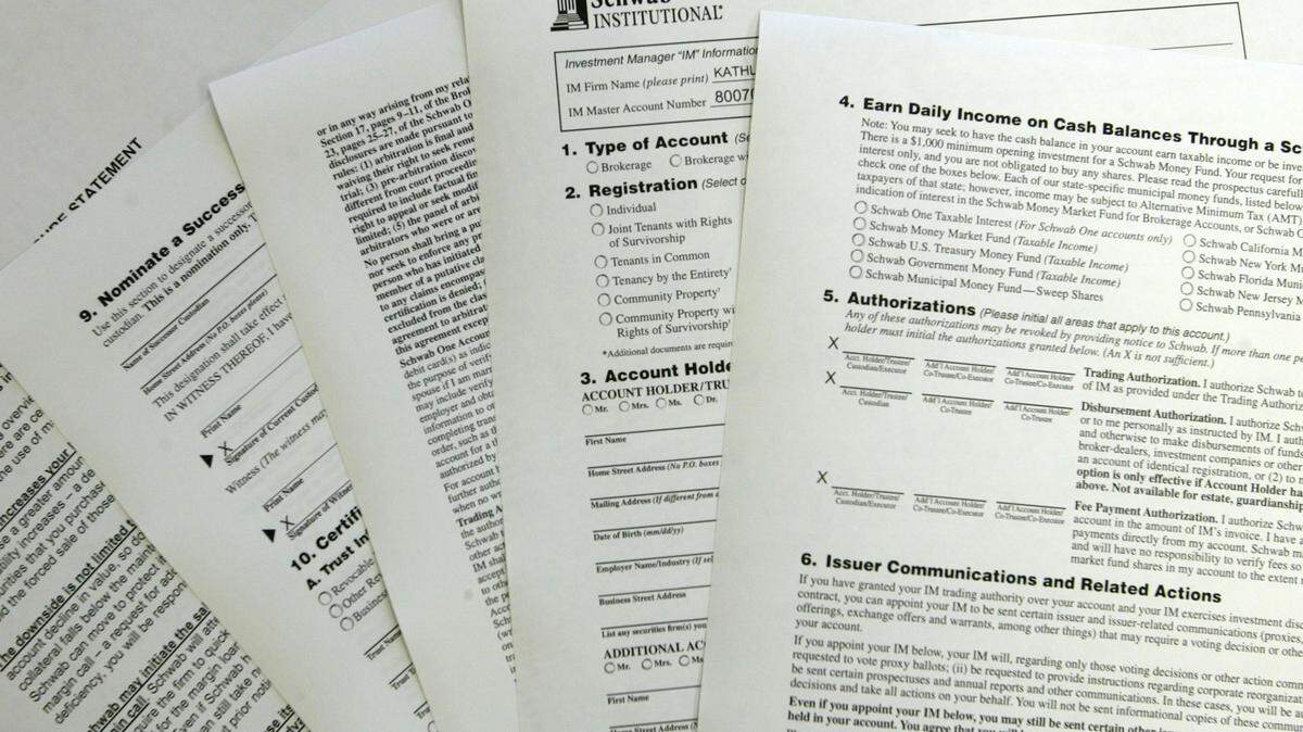 A pile of brokerage account application forms