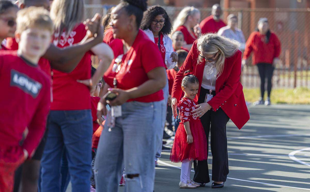 Driftwood Elementary School Principal Ann Marie Stramanak hugs a student as they gather in the shape of the word “LOVE” as they participate in a day of commemoration honoring the victims of the Marjory Stoneman Douglas High School tragedy on Friday, Feb. 13, in Hollywood.