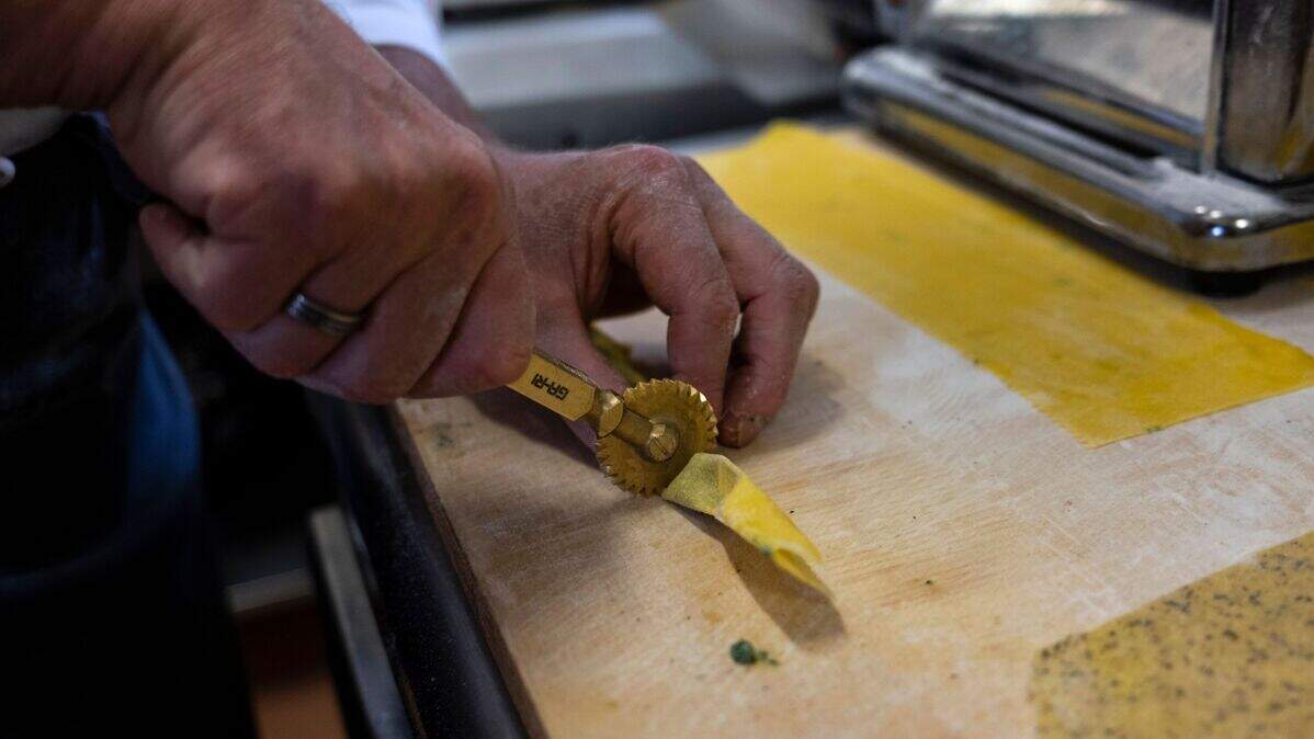 A chef prepares homemade pasta.