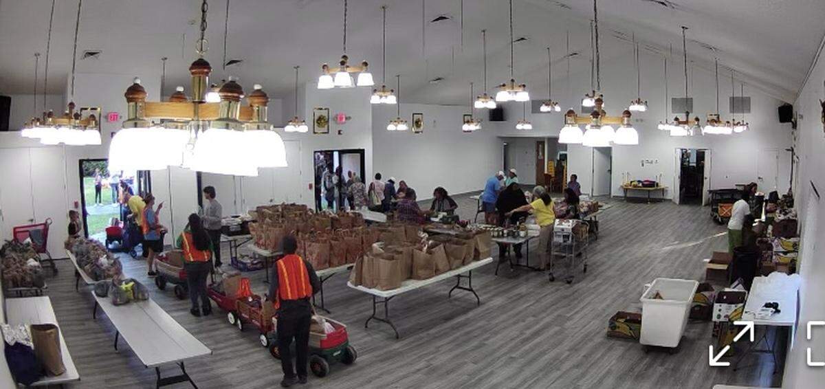 Before the pantry opens to the public, volunteers organize tables and wagons full of food.