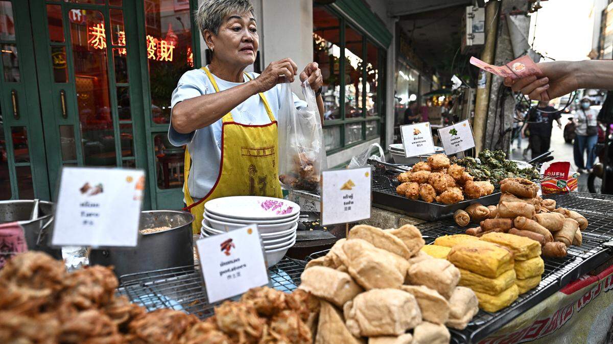 A street food vendor selling fried vegetarian snacks in Chinatown in Bangkok