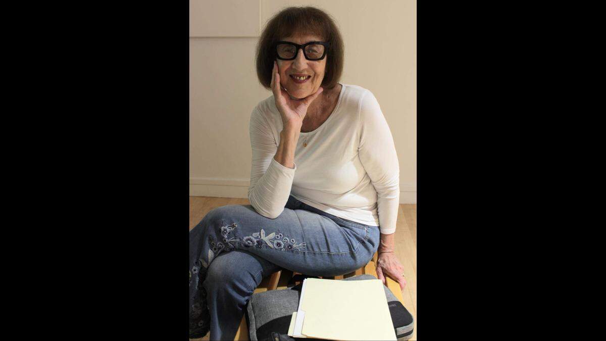 Cheryl Maeder, a Broward County-based conceptual filmmaker, sits for a portrait in the Coral Springs Museum of Art main gallery.