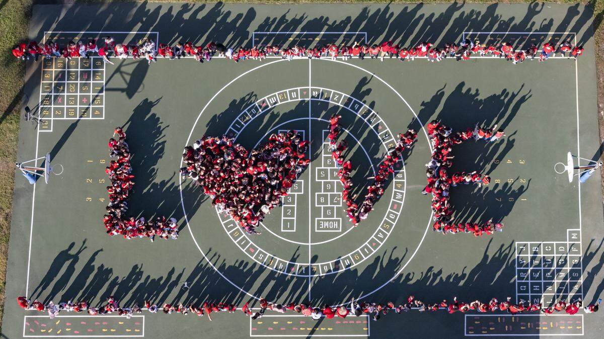 Driftwood Elementary School students gather in the shape of the word ‘LOVE’ as they participate in a day of commemoration honoring the victims of the Marjory Stoneman Douglas High School tragedy on Friday, Feb. 13, in Hollywood.