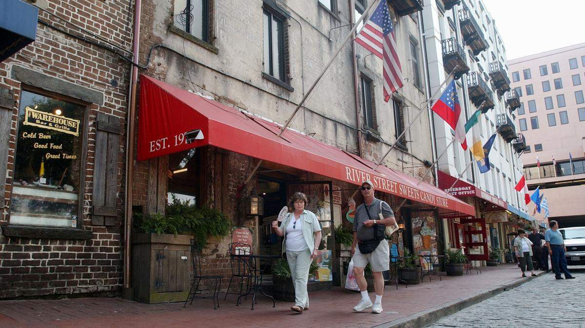 Tourists walk along River Street in Savannah, Georgia.