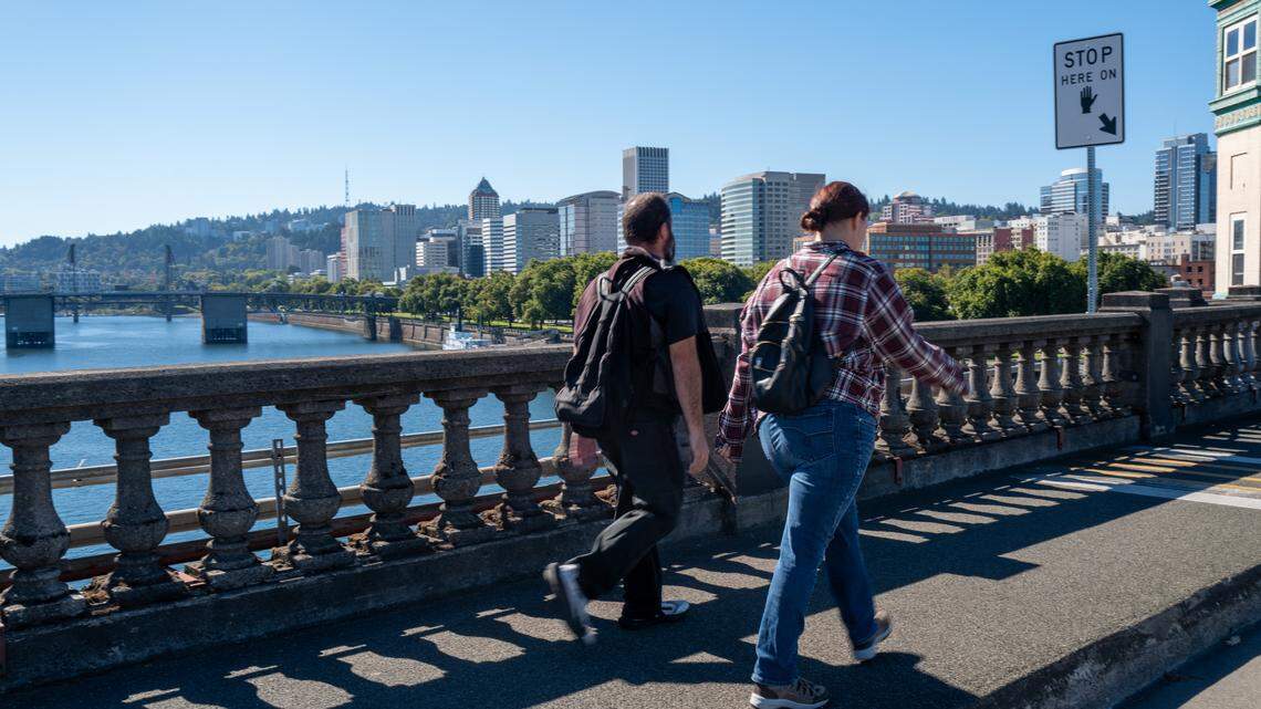 People walk along the water in Portland, Oregon.
