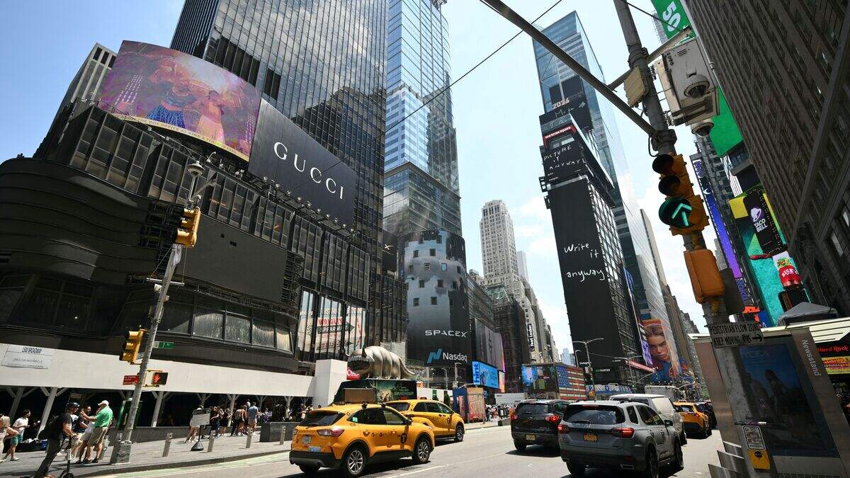Ads are displayed on screens at Times Square in NYC.