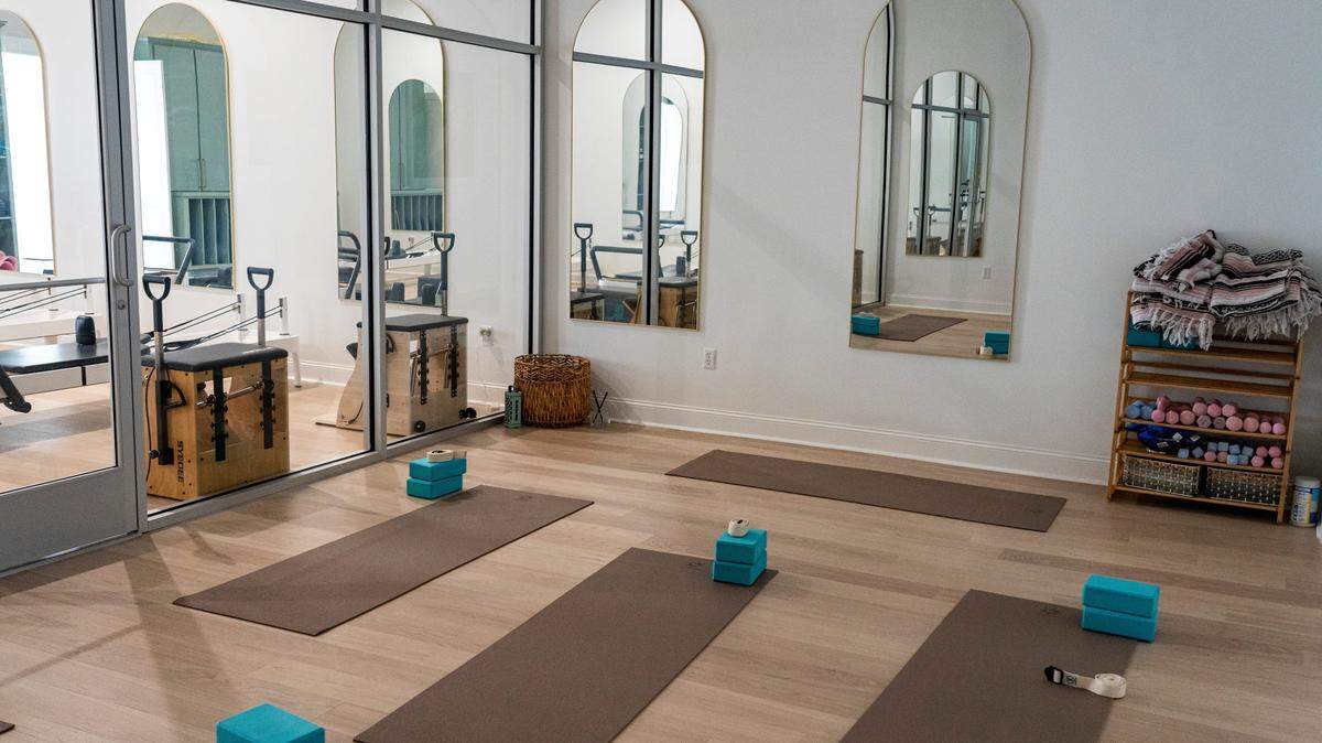 Yoga mats set up for class in a yoga studio.