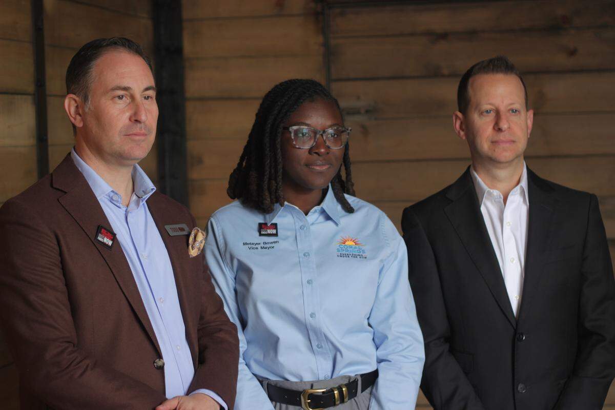 From left to right, Todd Cohn, Nancy Metayer Bowen and Jared Moskowitz pose for a photo after going through the cattle car experience together.