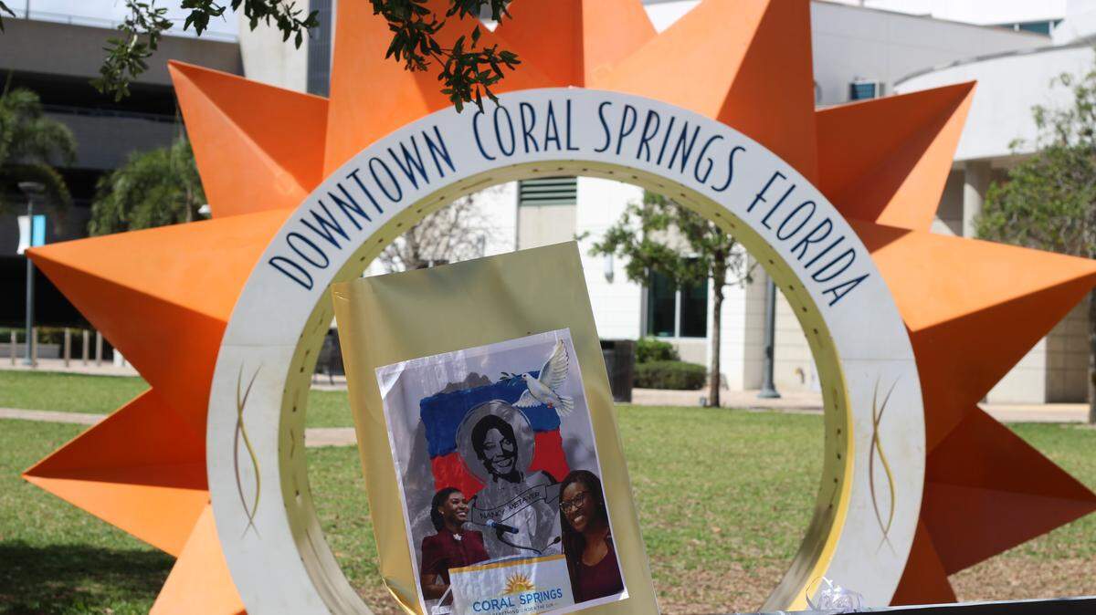 A sign memorializing Coral Springs Vice Mayor Nancy Metayer Bowen in front of the city’s iconic sun sculpture.