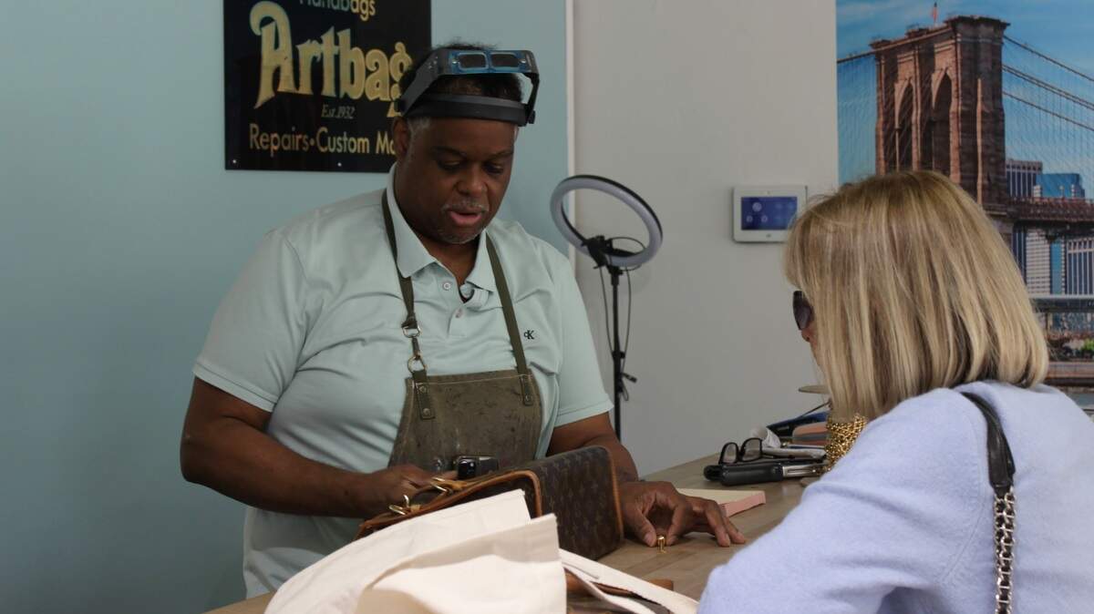 Chris Moore interacts with a customer at his Artbag store in Coral Springs.