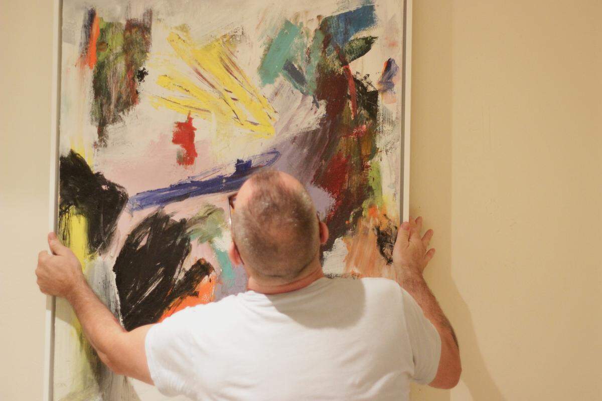 Tommaso Fattovich repositions one of his favorite paintings currently stored at his parents’ home.