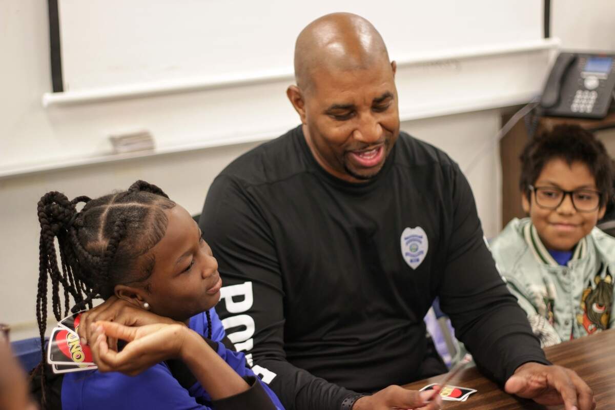 School Resource Officer Brian Gasper, center, plays UNO with students at the Coral Springs Police Department’s summer camp on July 8, 2026.