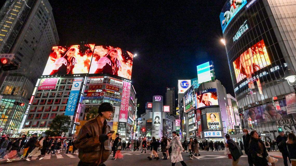 Pedestrians walk through Shibuya Crossing in Tokyo.