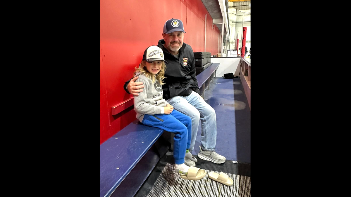LJ Howells and Coral Springs Commissioner Joe McHugh pose for a photo at a Junior Panthers practice.