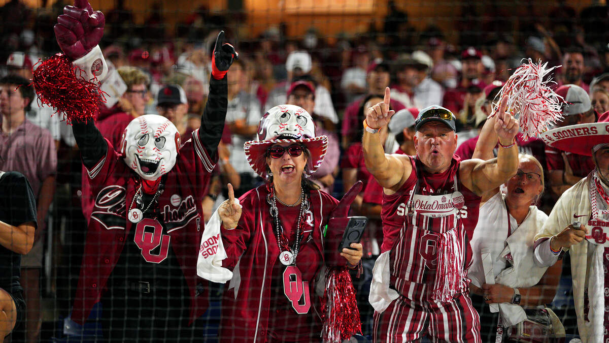 Oklahoma Sooners fans celebrate in the stands after a win.
