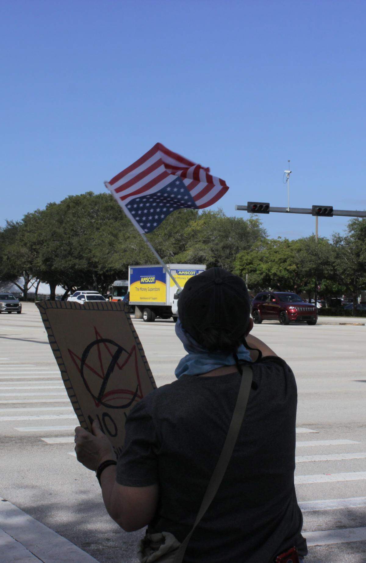 A protester waves an upside-down American flag in Coral Springs.