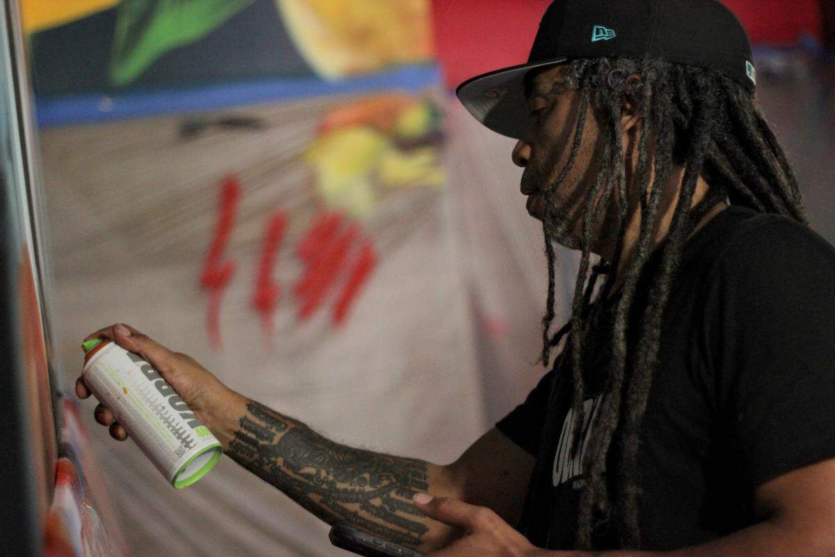 Ubiera works on his mural at Gary Rack’s Farmhouse Kitchen in Coral Springs.