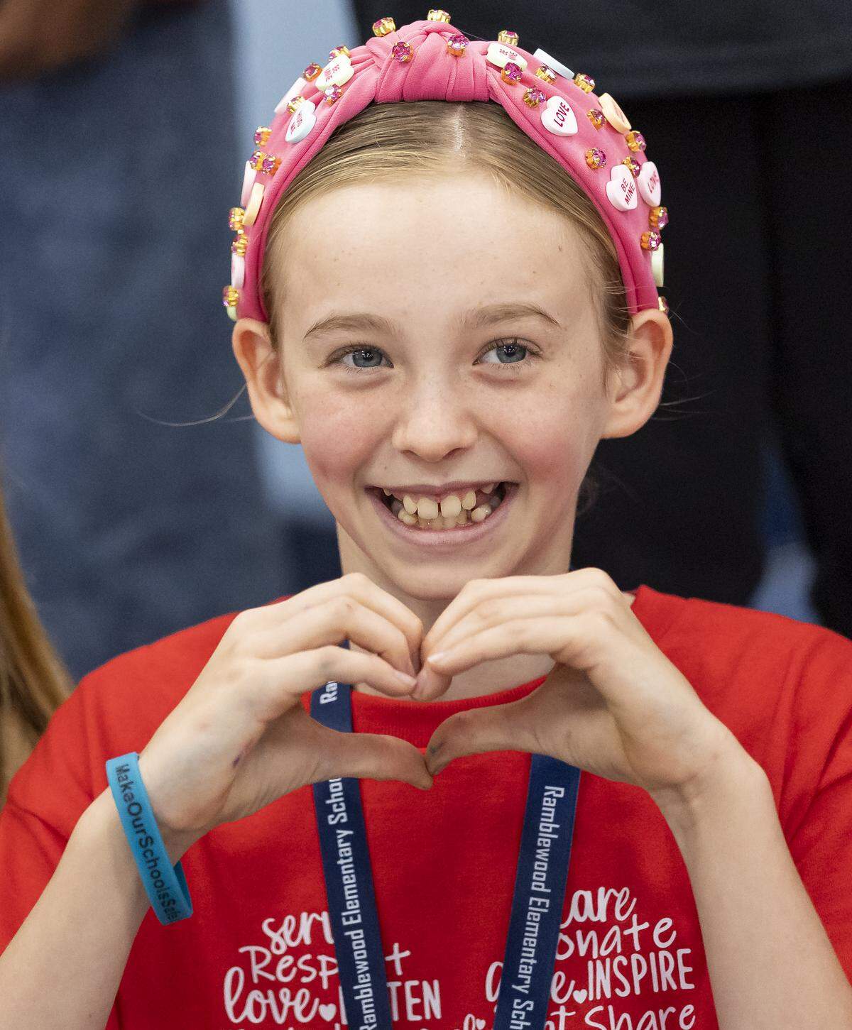 Fifth grader Madi Marcus, 10, makes a heart with her hands after preparing “Weekend Packs” for children in need as Ramblewood Elementary School participates in a day of commemoration honoring the victims of the Marjory Stoneman Douglas High School tragedy on Friday, Feb. 13, in Coral Springs.