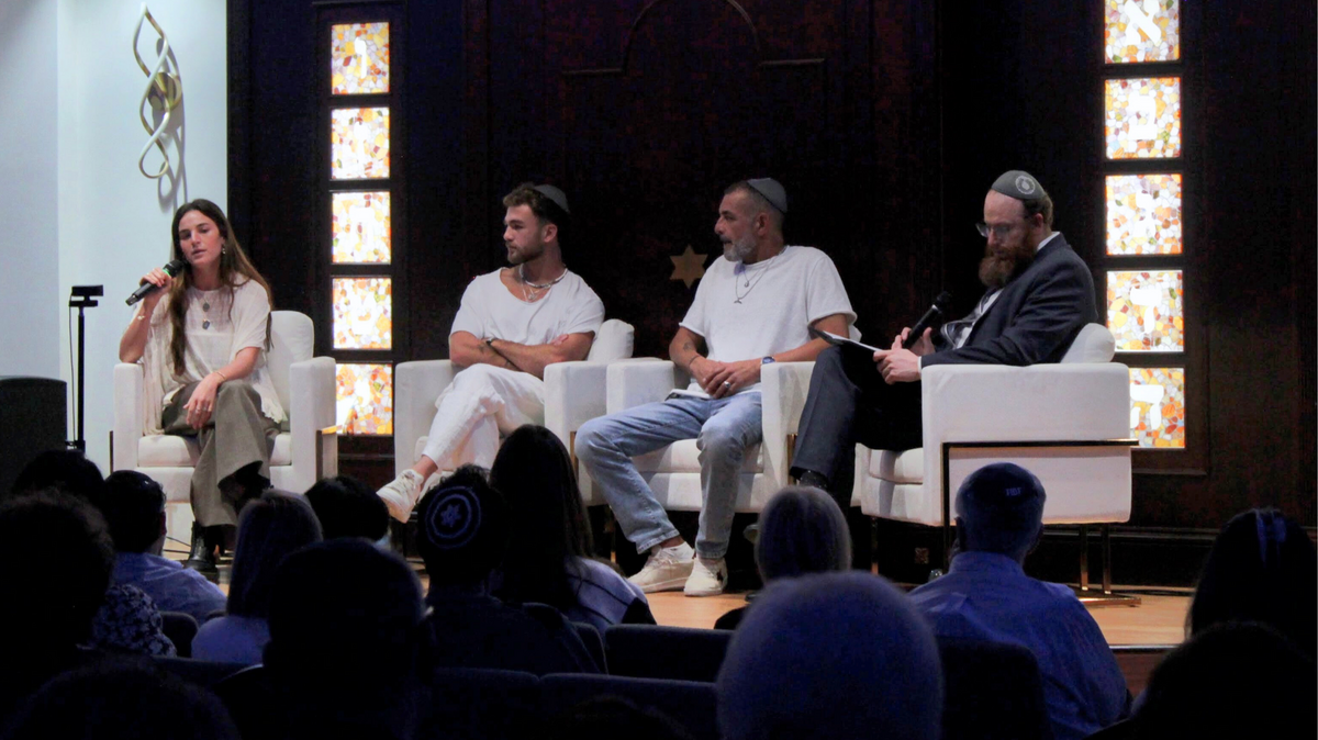 Maya Regev, left, speaks about her experiences as a Hamas hostage in front of a packed hall at Chabad of Southwest Coral Springs on Dec. 7. She also translated for her brother and father, who do not speak English.