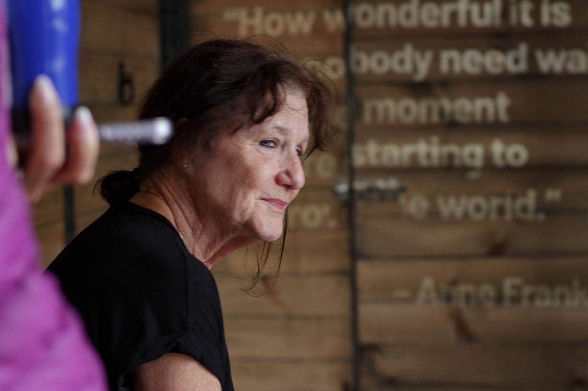 Amy Gilson looks out the cattle car door as the Hate Ends Now: Cattle Car Exhibit presentation ends.